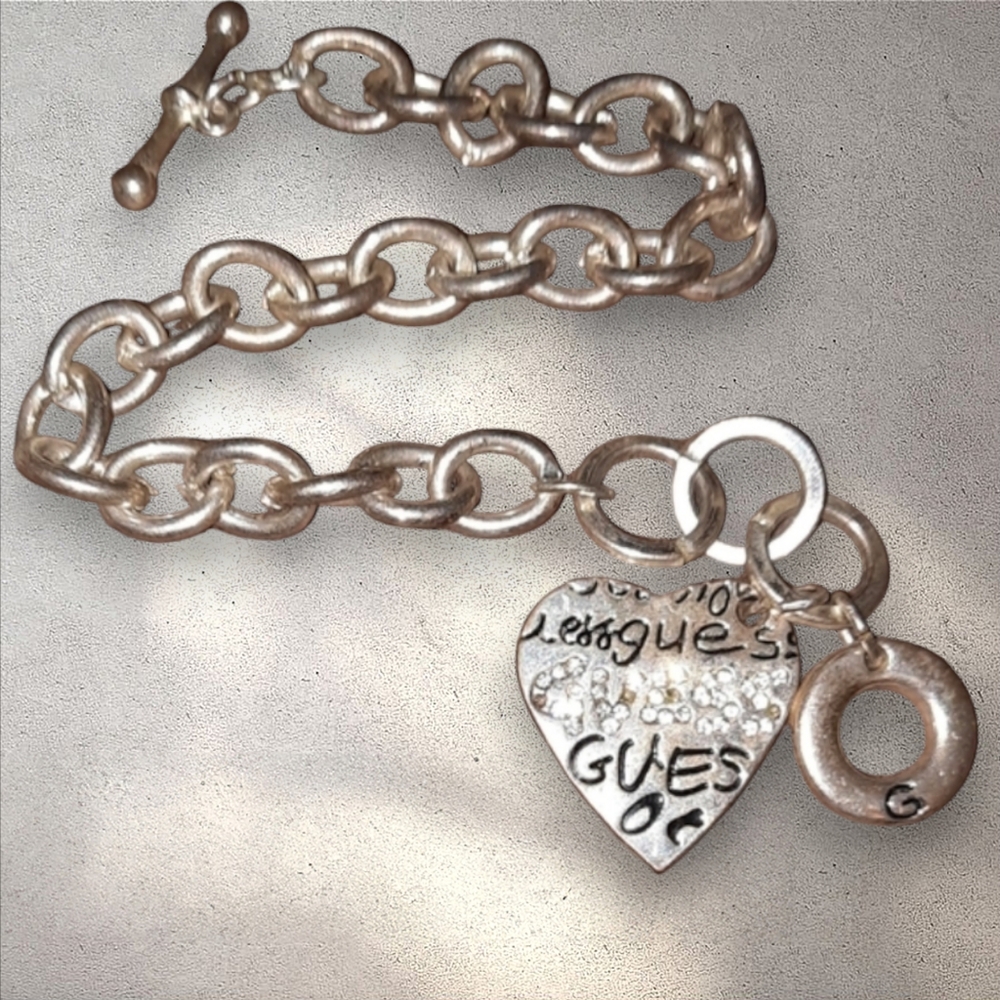 Guess! link silvertone G.bracelet with charm. toggle close designer Signed